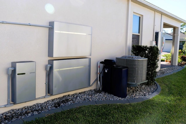 view of side of property with stucco siding and central AC unit