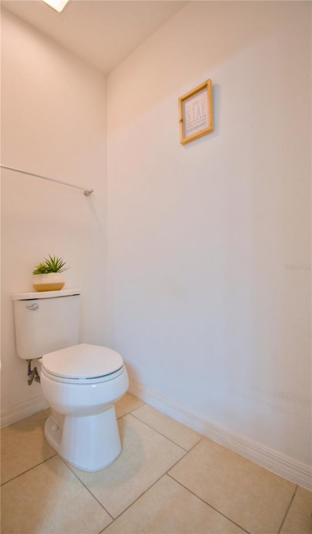 bathroom featuring tile patterned flooring, toilet, and baseboards