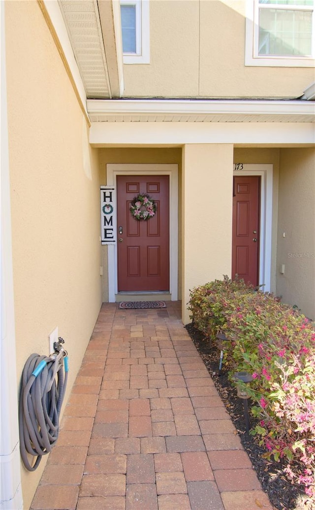 view of exterior entry featuring stucco siding