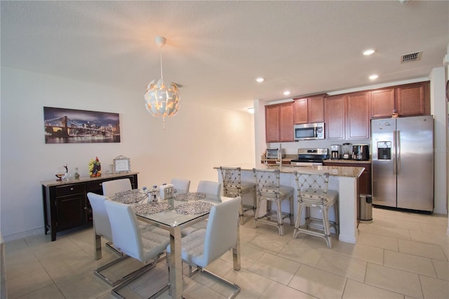 dining area featuring light tile patterned flooring, visible vents, and recessed lighting