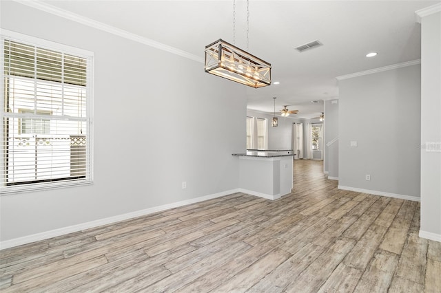 interior space featuring a ceiling fan, baseboards, light wood-style floors, visible vents, and crown molding