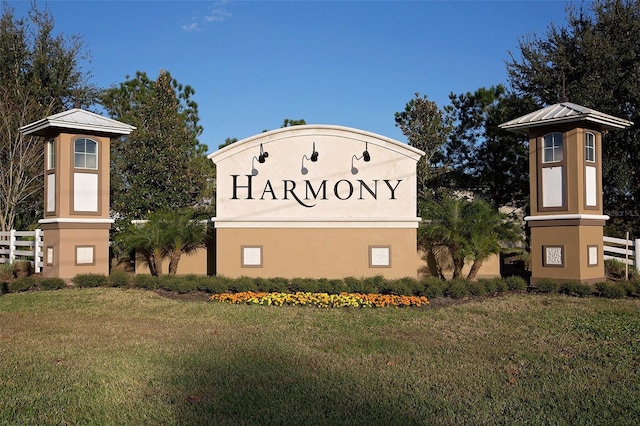 community sign with a lawn and fence