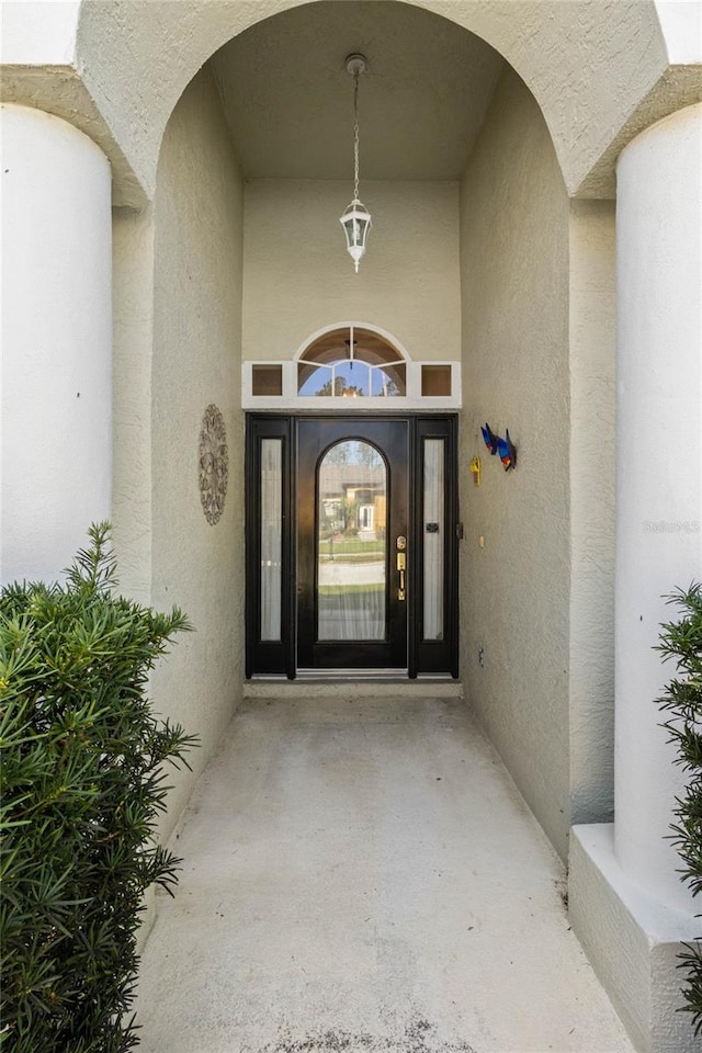 property entrance with stucco siding