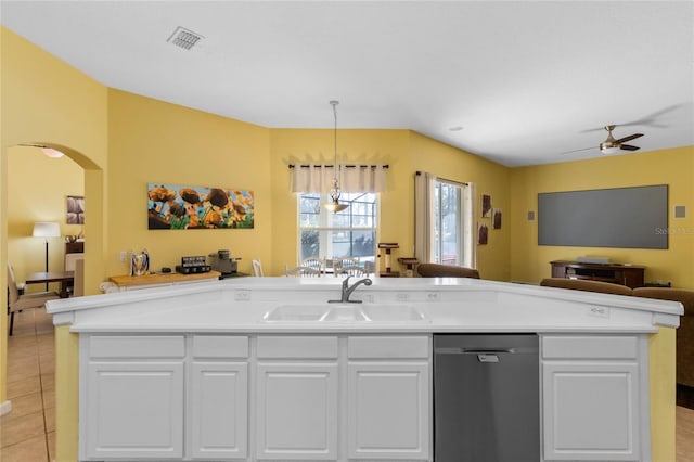 kitchen featuring visible vents, dishwasher, open floor plan, a sink, and light tile patterned flooring