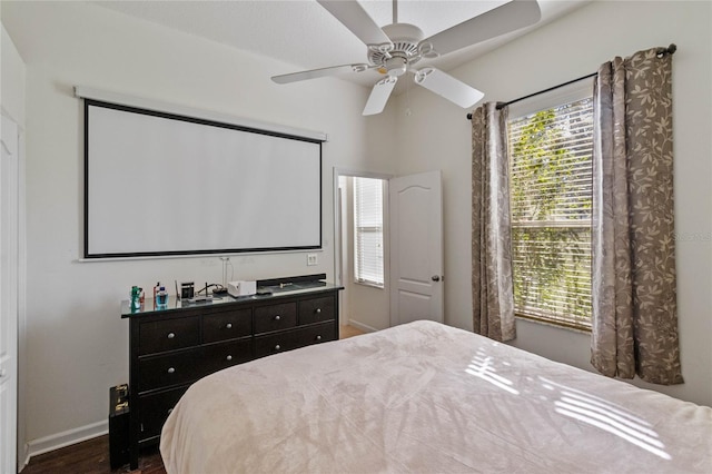 bedroom featuring ceiling fan, dark wood-type flooring, and baseboards