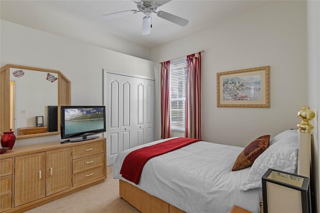 bedroom with light carpet, a closet, and a ceiling fan