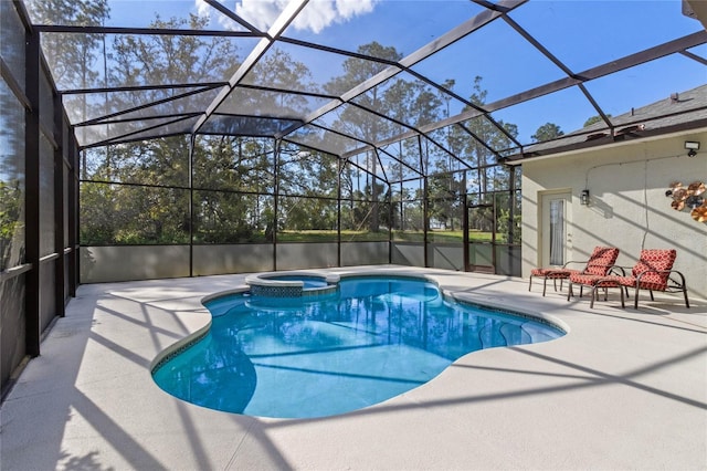 view of swimming pool with a patio, a lanai, and a pool with connected hot tub