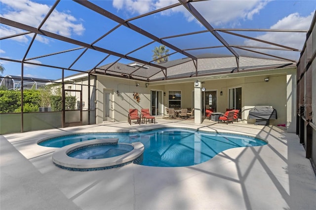 view of swimming pool featuring a lanai, a patio area, and a pool with connected hot tub