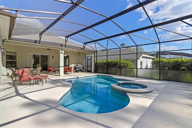 view of swimming pool featuring ceiling fan, a patio, a lanai, and a pool with connected hot tub