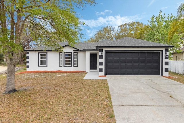 single story home with driveway, a shingled roof, an attached garage, fence, and stucco siding