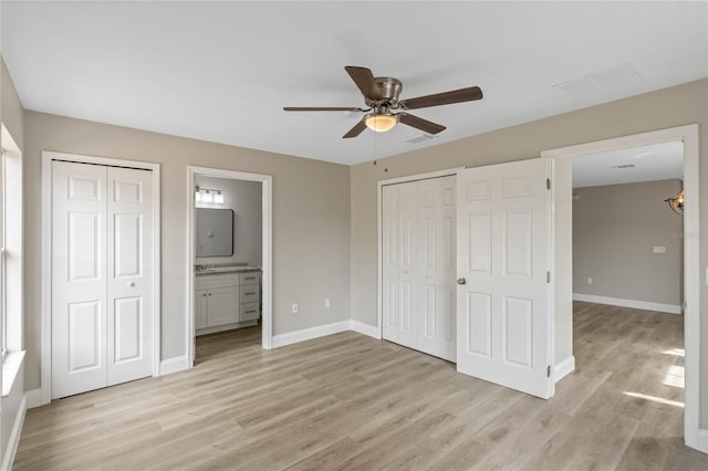 unfurnished bedroom with visible vents, connected bathroom, light wood-style flooring, and baseboards