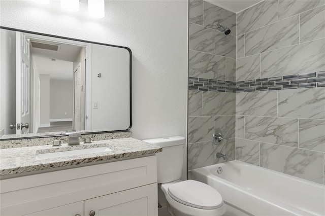 bathroom with toilet, a textured wall, vanity, and shower / bathing tub combination