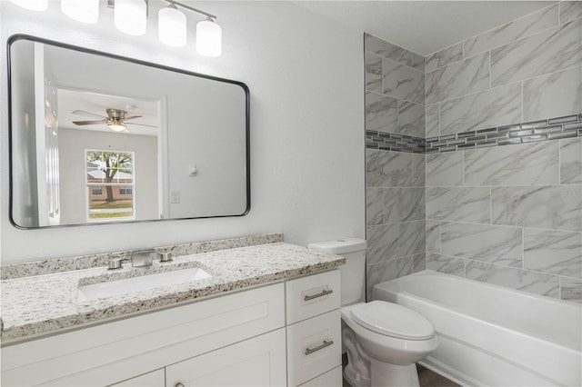 full bathroom with a ceiling fan, washtub / shower combination, vanity, and toilet