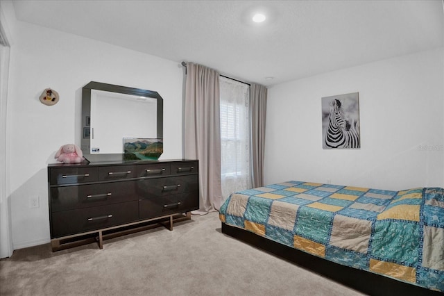 bedroom featuring light colored carpet