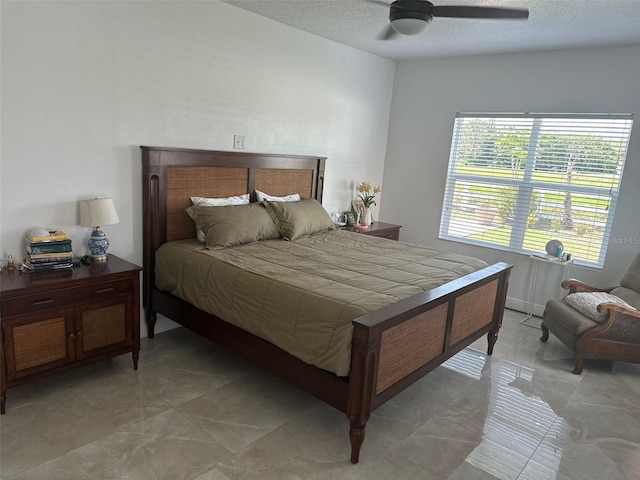 bedroom with a textured ceiling and ceiling fan