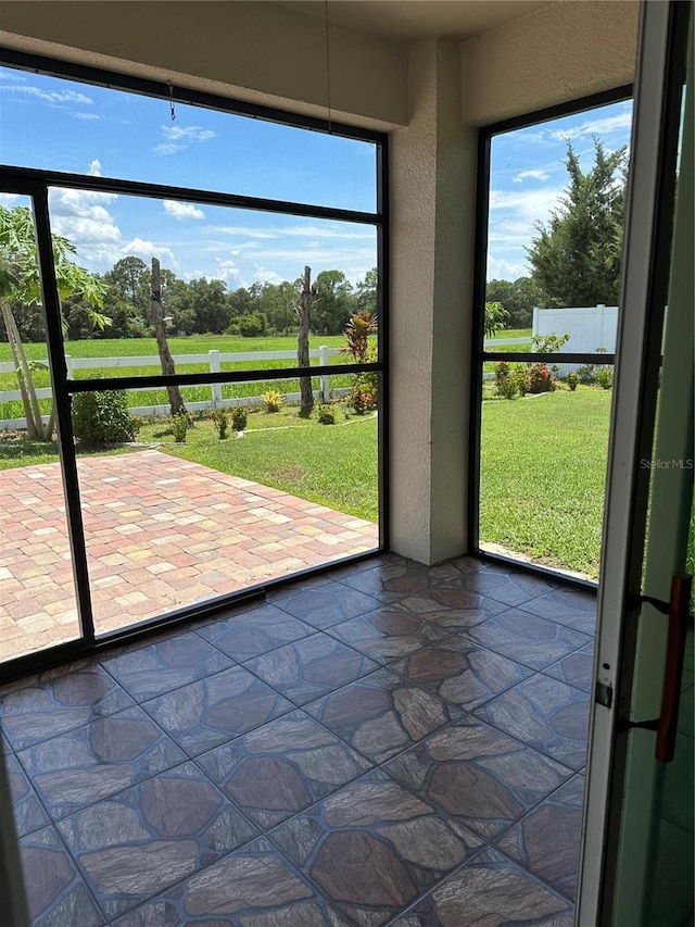 unfurnished sunroom with plenty of natural light