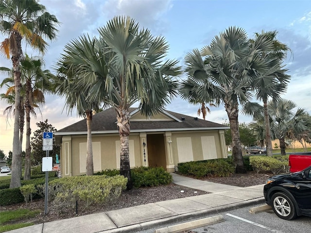 view of front of property with uncovered parking and stucco siding