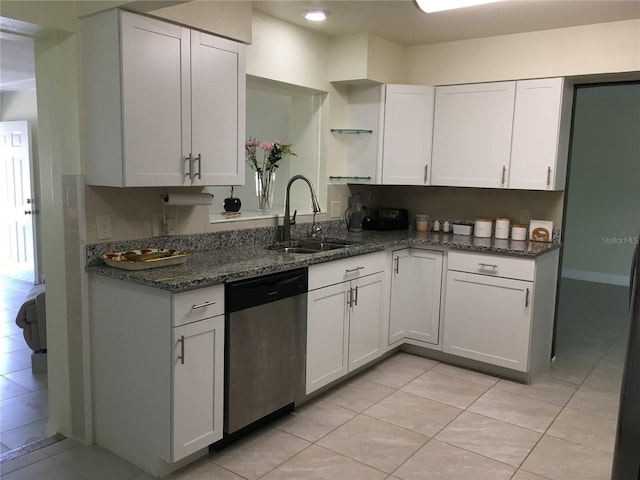 kitchen with dark stone counters, a sink, white cabinets, dishwasher, and open shelves