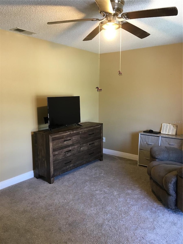 carpeted living room with a textured ceiling, a ceiling fan, visible vents, and baseboards