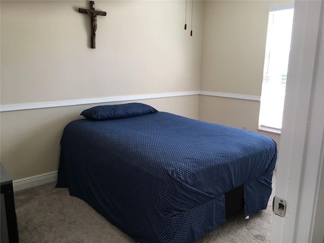 bedroom featuring carpet floors and baseboards