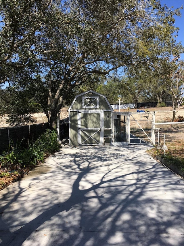 view of shed featuring fence