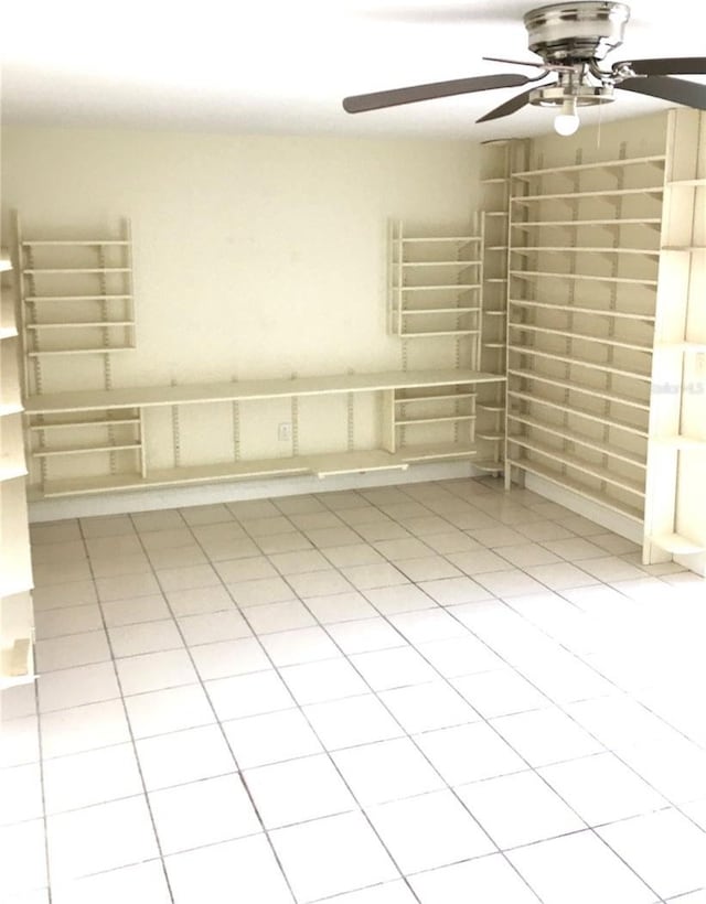spare room featuring tile patterned flooring and ceiling fan