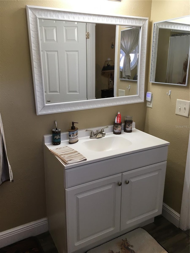 bathroom with vanity and baseboards