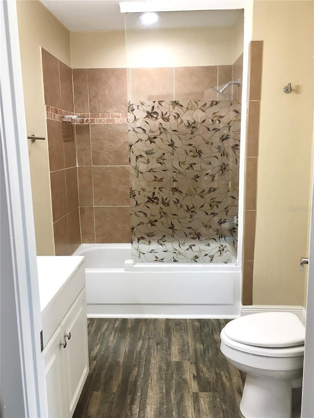 bathroom with shower / tub combination, wood finished floors, toilet, and vanity