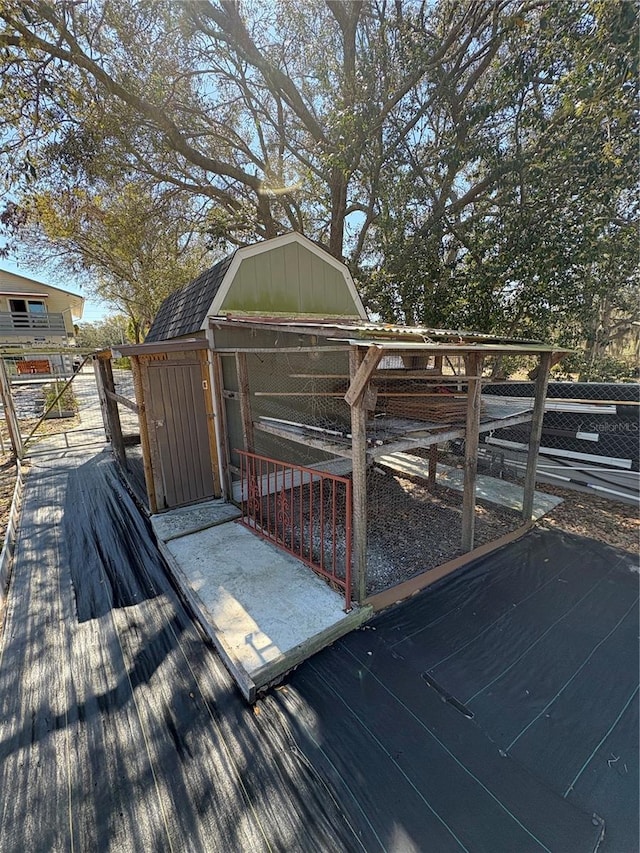 wooden deck featuring a storage unit and an outbuilding