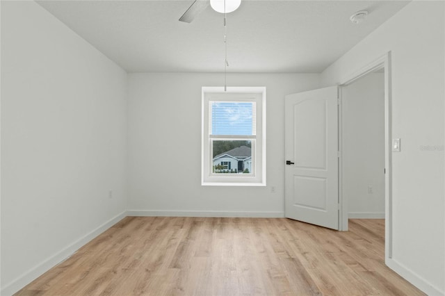 interior space with light wood-style flooring, baseboards, and a ceiling fan