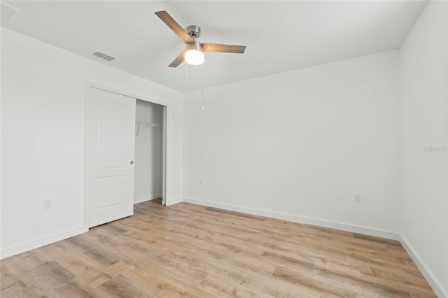 unfurnished bedroom with a closet, visible vents, light wood-style floors, a ceiling fan, and baseboards