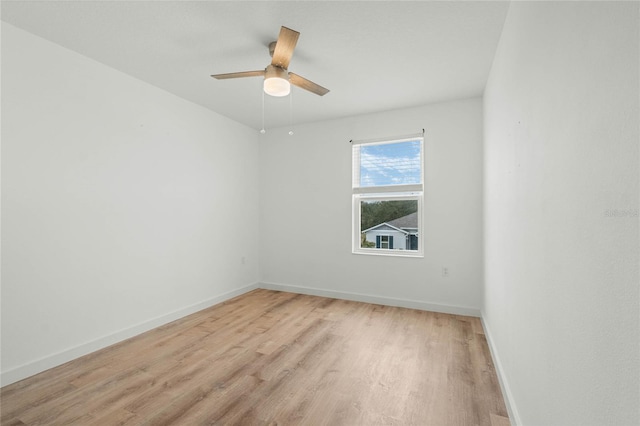 empty room with light wood-style floors, baseboards, and a ceiling fan