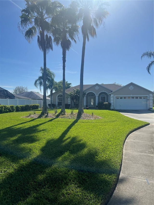 view of front of property with a garage, concrete driveway, and a front yard