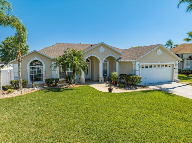 view of front of house with a front lawn, a garage, and stucco siding