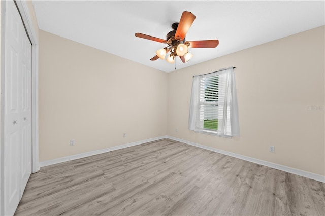 3303 Ann Arbor Ct, Saint Cloud, FL 34772 - unfurnished bedroom featuring a closet, light wood-type flooring, baseboards, and a ceiling fan