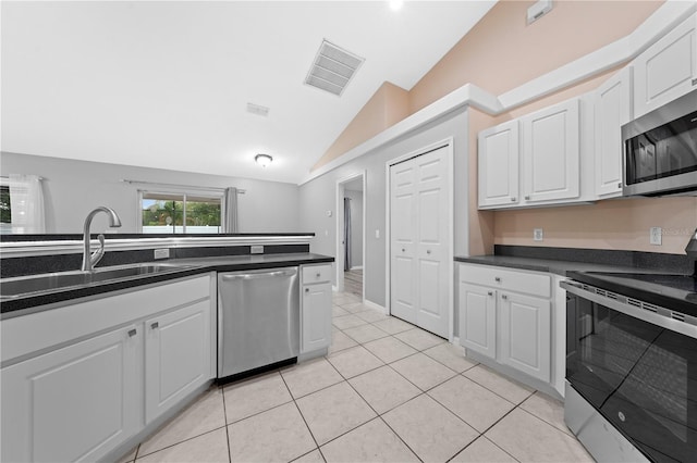 3303 Ann Arbor Ct, Saint Cloud, FL 34772 - kitchen featuring a sink, dark countertops, visible vents, appliances with stainless steel finishes, and vaulted ceiling
