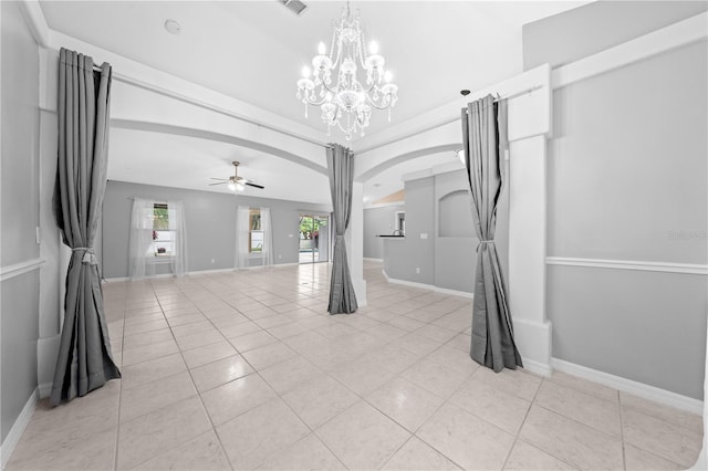 3303 Ann Arbor Ct, Saint Cloud, FL 34772 - empty room with light tile patterned floors, baseboards, ceiling fan with notable chandelier, and arched walkways