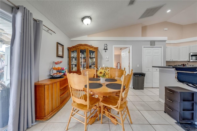 3303 Ann Arbor Ct, Saint Cloud, FL 34772 - dining room featuring vaulted ceiling, light tile patterned floors, and visible vents