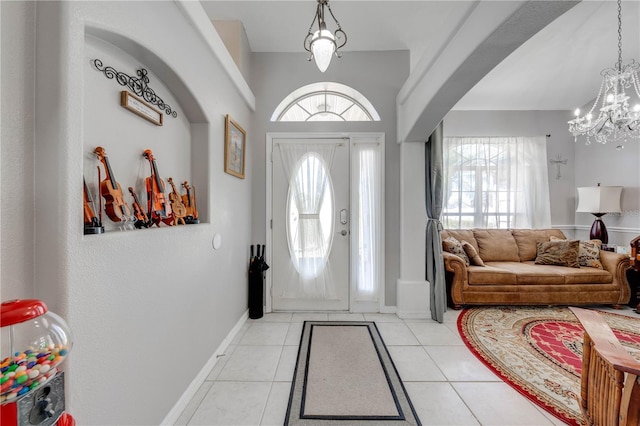 3303 Ann Arbor Ct, Saint Cloud, FL 34772 - foyer featuring light tile patterned floors, a chandelier, baseboards, and a healthy amount of sunlight