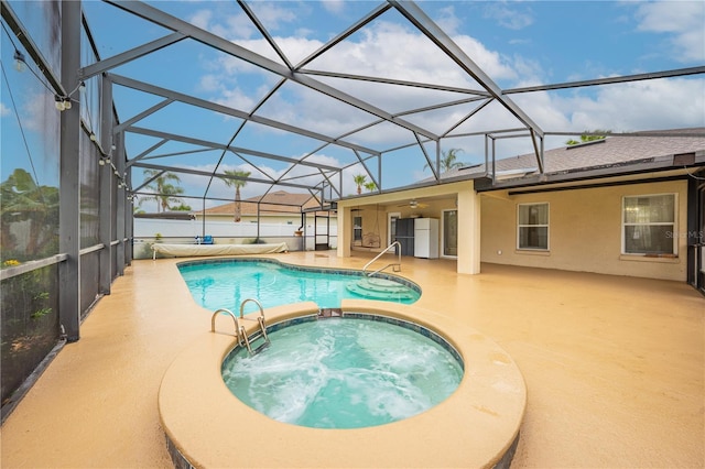 3303 Ann Arbor Ct, Saint Cloud, FL 34772 - view of pool with a patio area, glass enclosure, a fenced in pool, a ceiling fan, and an in ground hot tub