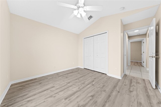 3303 Ann Arbor Ct, Saint Cloud, FL 34772 - unfurnished bedroom featuring a closet, visible vents, vaulted ceiling, light wood-style flooring, and baseboards