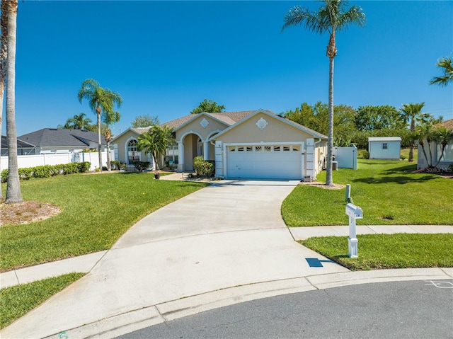 3303 Ann Arbor Ct, Saint Cloud, FL 34772 - single story home with an attached garage, stucco siding, fence, concrete driveway, and a front yard