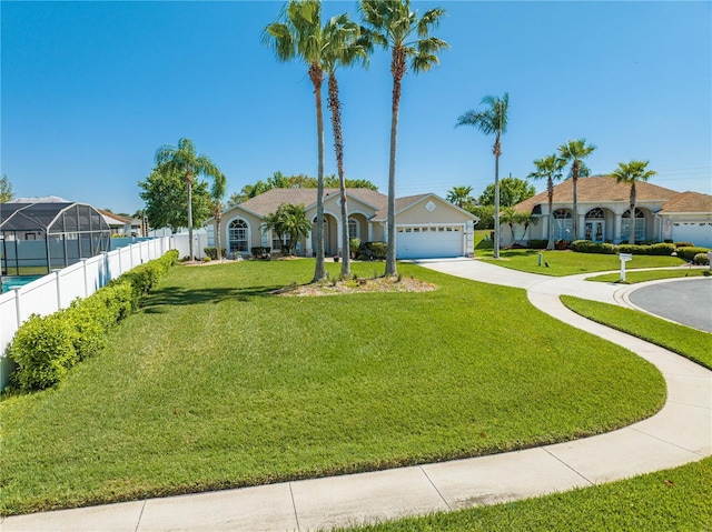 3303 Ann Arbor Ct, Saint Cloud, FL 34772 - view of front of property with a front yard, concrete driveway, fence, and a garage