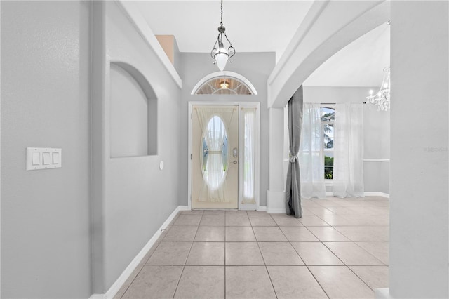3303 Ann Arbor Ct, Saint Cloud, FL 34772 - tiled entrance foyer featuring an inviting chandelier, baseboards, and arched walkways