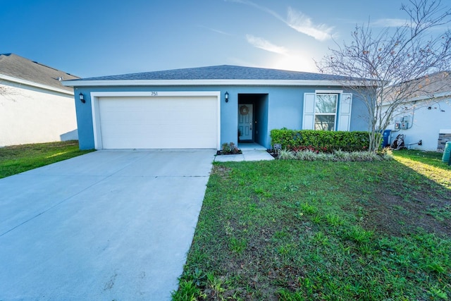 single story home with a garage, a shingled roof, concrete driveway, stucco siding, and a front lawn