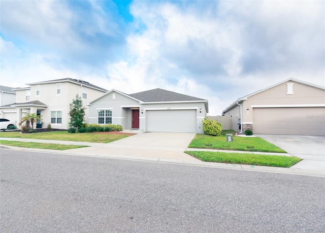 view of front of property featuring roof with shingles, stucco siding, an attached garage, driveway, and a front lawn