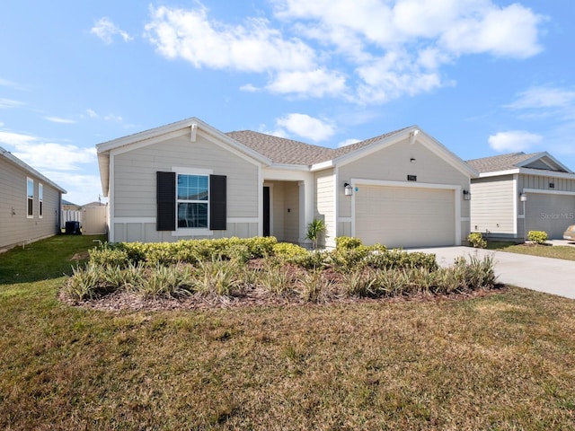 ranch-style home with roof with shingles, concrete driveway, an attached garage, board and batten siding, and a front yard