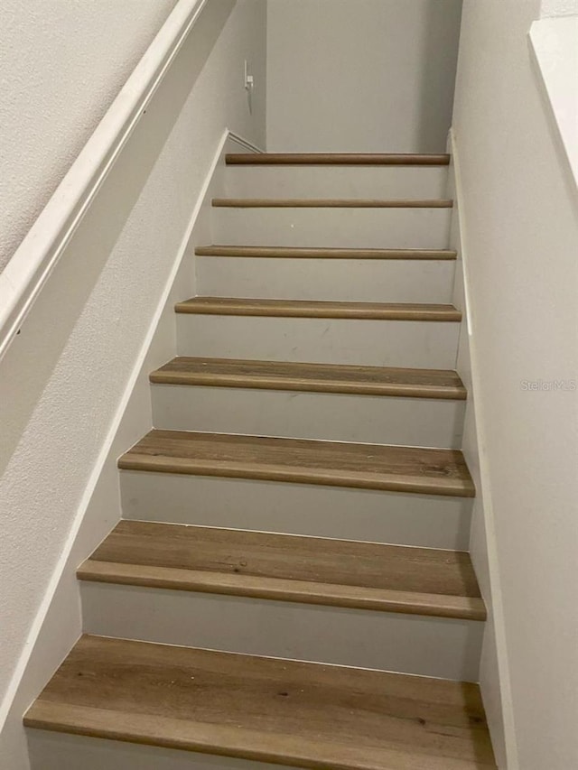 staircase with wood finished floors