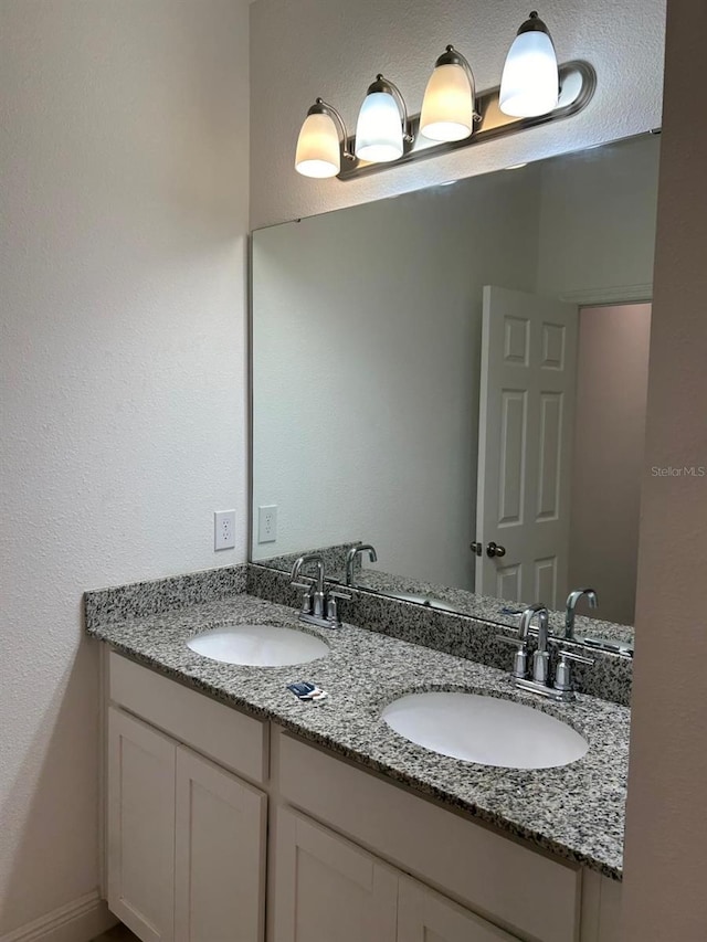 bathroom featuring double vanity and a sink