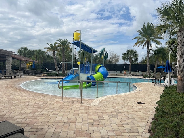 view of pool featuring playground community, a patio, and a water play area